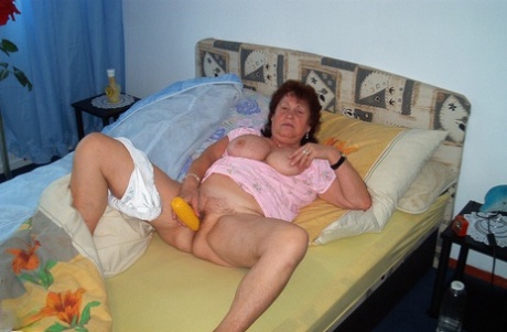 Aged 85-year-old grandmother Brigitte reveals her plump figure and playfully cuddles with her big boobs.