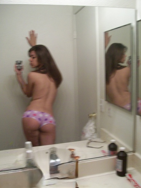 Amateur teen shows her petite body in panties while taking nude photos