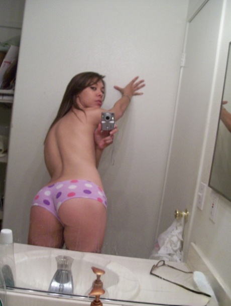 Uncommon teenager exhibits her petite body in panties while taking nude photos.