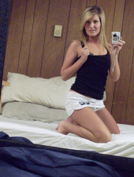 Self-posed amateur blonde Adrina Scott takes pictures of herself, stripping off and posing in front of the mirror.