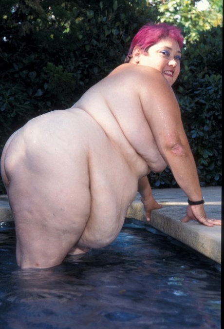 The alluring sight of BBW Cadence Harden stripping and showing off in the nude by the poolside is on display.