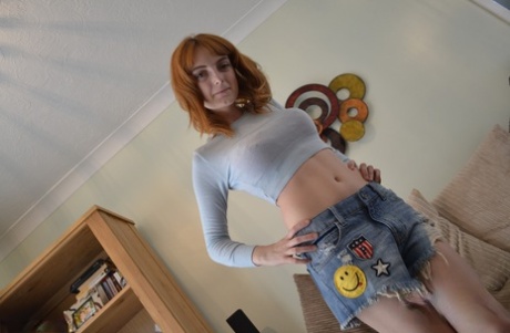 Redheaded Vixen Strips Her Clothes Off And Gives A Perverted Nerd A BJ