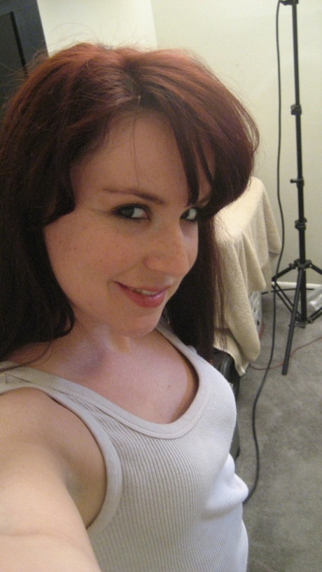 The amateur ginger, Jaimee Saunders, grasps her breasts and displays her trimmed vagina.