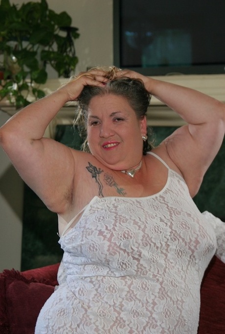 The solo pose is taken by fat mature Patty Godfrey as she releases her saggy big tits.