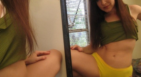 The amateur vixen, Jaimee Saunders strips in front of the mirror while posing for photos.