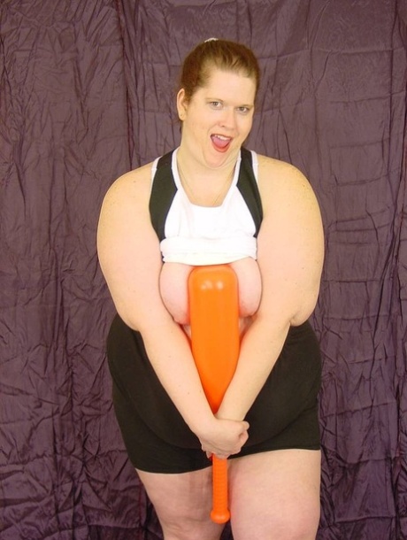 Her tightly shaved partner, Naughty SBBW, plays with her baseball bat and toys around.