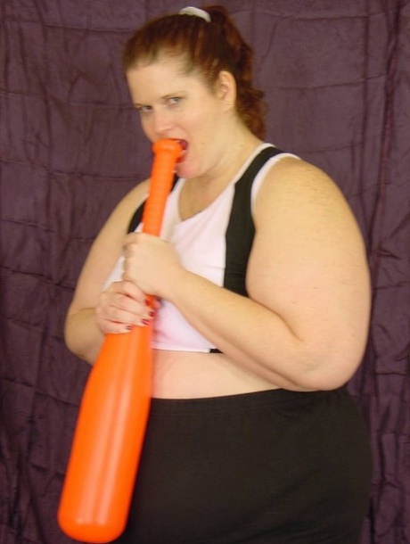 A baseball bat is used by Naughty SSBBW to playfully cuddle her tight-shaved, moaning female partner.