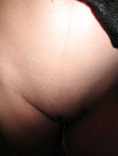 A young woman dressed in black lingerie exhibits her small toestain and masturbation wounds up close.