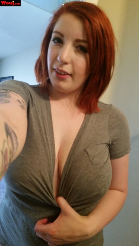 WouJ, a full-figured redhead, is seen taking selfies with her juicy tits and teasing others.