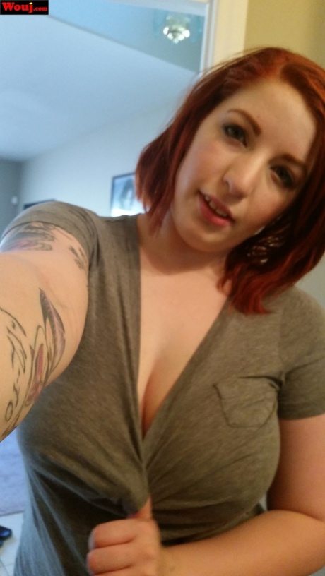 Hot, full-figured redhead WouJ tagging at her juicy tits while taking selfies.