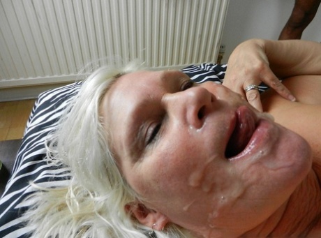 Naughty granny Lacey Starr gets a messy facial in a steamy interracial scene.