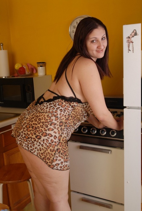 In the kitchen, fat Latina Sonia strips, demonstrates her big tits, and rubs her twats.