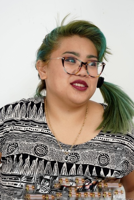 Manila Bey, a fat green-haired Asian girl, displays her thick body and hairy strands.