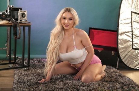 Big natural tits: Skylar Vox, the pornstar, is spooned on to the sofa.