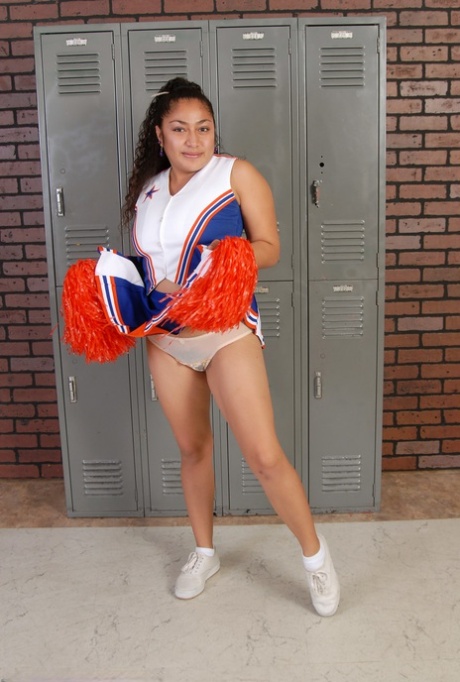 Petite Curly Haired Cheerleader Reena Shows Her Fat Ass And Hairy Pussy