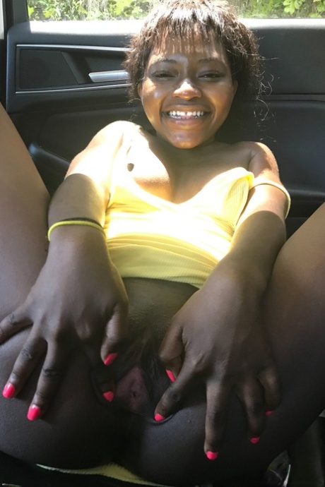 In a solo performance, the petite ebony Noemie Bilas exposes her tits, pussy, and feet.