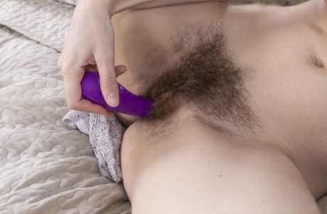 A purple dildo and hairy pussy is the focal point of MILF's flirtatious behavior, as Emily Rose attempts to capture her hair in one piece.