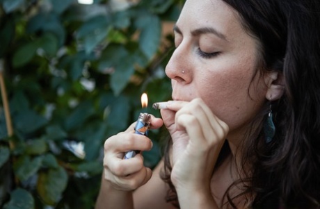 Working girl: Nikki Silver, pictured naked in front of mirrors smoking Spliff, poses for pictures with her boyfriend.