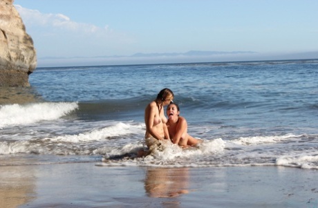 On the beach, amateur models wearing pinkish tits and puffy hair doing yoga poses.