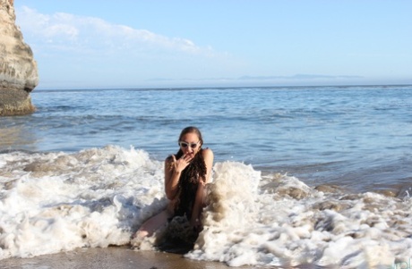 During her beach outing, Maggie Mayhem, an amateur entertainer, teases with her big tits.