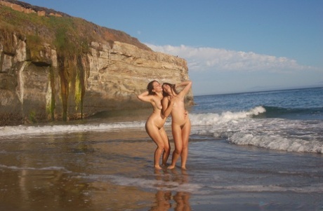 On the beach, young amateur sexts with hairlines in large tiaras are seen in a nude attire.