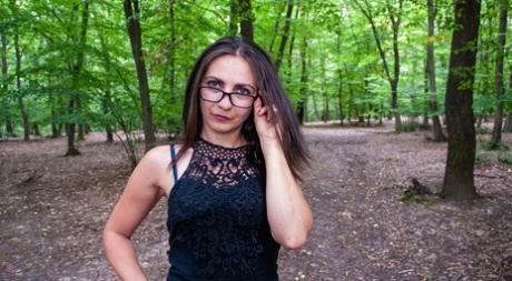 With her glasses on, Anna flaunts her large booty while barking in the woods.