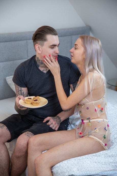 A naked beauty named Bernie Svintis undresses and rides her tattooed partner's cock.