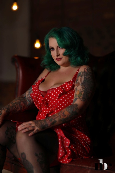 Galda Lou, the model with chubby green hair, exposes her impressive breasts and large buttocks.