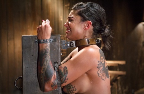 Bonnie Rotten, a brunette with big breasts, is bound and toyed with.