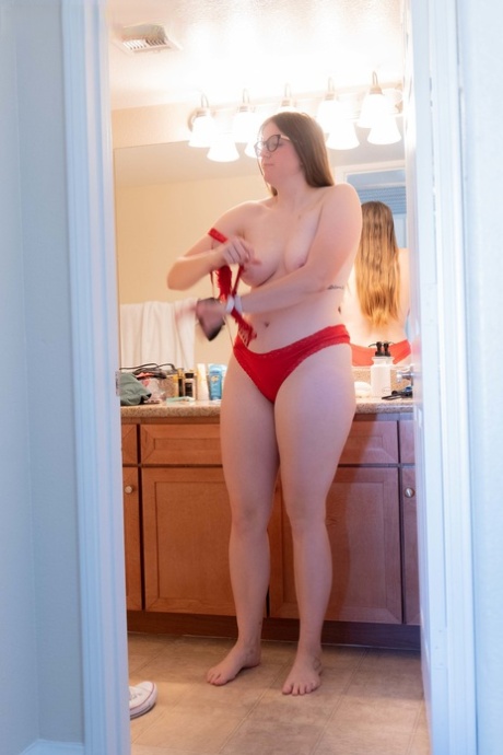 A video captures Jacklyn, a fatty amateur, changing her attire in the bathroom.