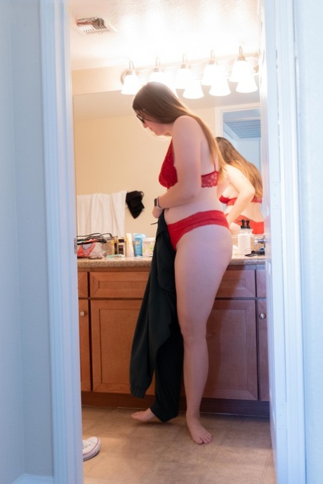 A camera captures Jacklyn, an amateur fat woman, changing her clothing in the bathroom.