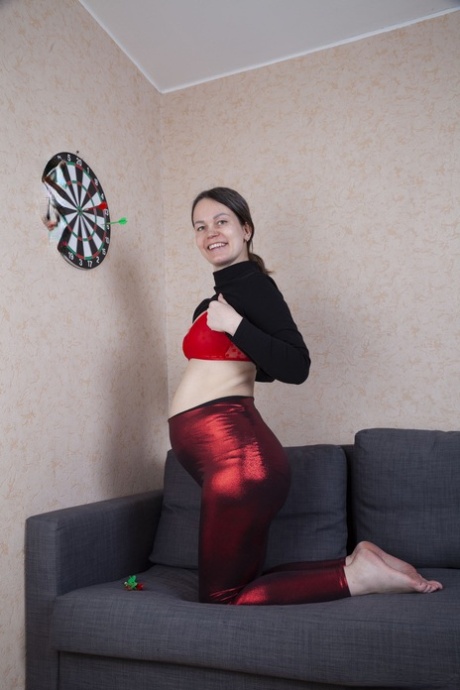 The amateur player Iva bares her hairy pussy and touches it while playing darts.