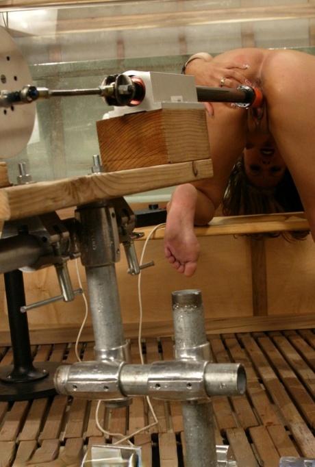 Jennifer Luv's alluring curve is achieved as she bends over a table and uses a dildo machine to pump her vagina.