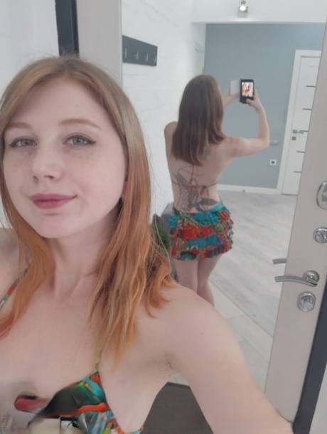 Badly embarrassed prostitutes strip down and pose without clothes in front of the mirror.