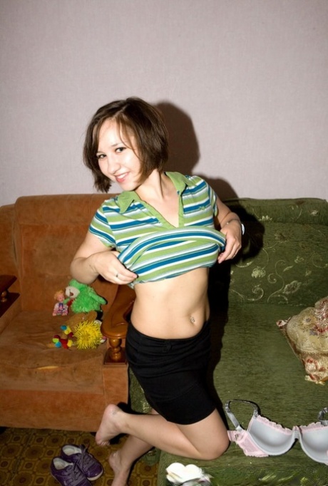 Homemade striptease: Brunette amateur shows off her juicier busts in a scene.