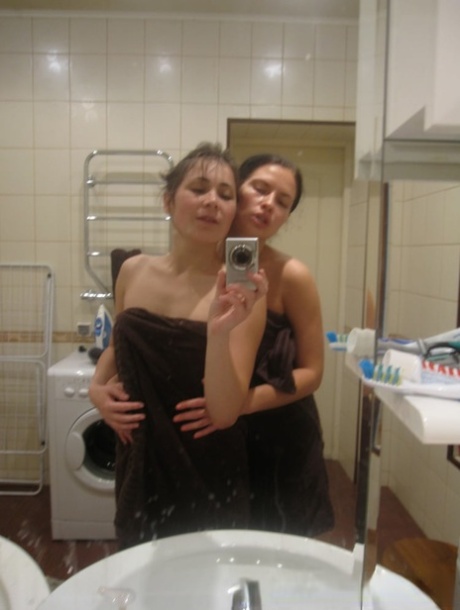 Fancy amateur lesbians pose for selfies while stripping and making out in the bathroom.