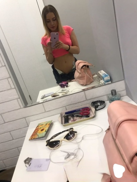 A blonde novice captures nude selfies, displaying her lovely little tits.