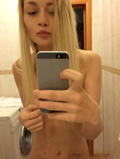 She shows off her perfect body as a blonde amateur takes nude selfies.