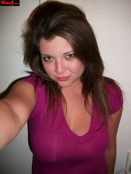 Wearing a shiny pink dress, WouJ showcases her breasts as an amateur brunette.