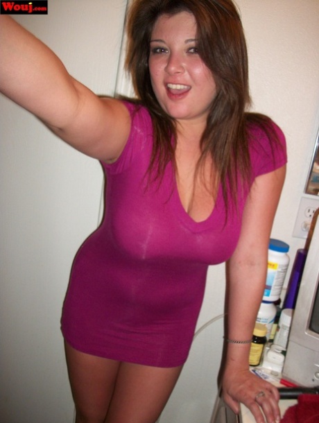 WouJ, a brunette amateur, displays her breasts in a bright pink dress.