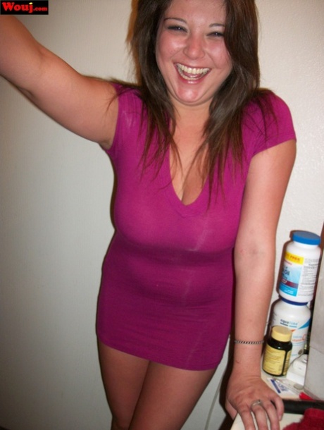 Woreauty: Brunette amateur WouJ wears a shiny pink dress to show off her buttocks.