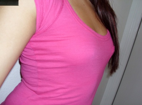 Hot Asian girl bares big bum in braless shirt in pink shirt.