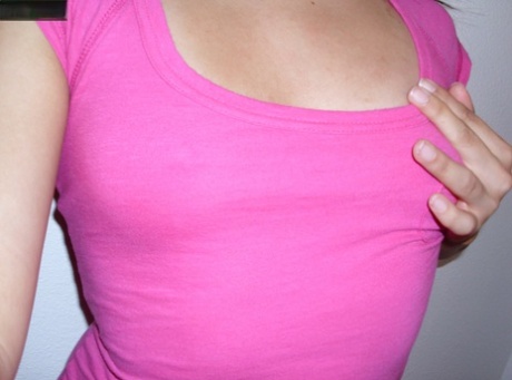 An Asian female with a sizable butch face flaunts her ample booty while wearing a pink shirt and no bra.