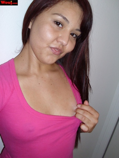 The curvaceous Asian lady exhibits her ample booty while donning a pink shirt without any bra.