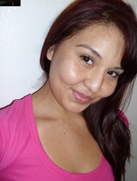 In her pink shirt, the hot Asian girl displays her large booty while posing without a bra.