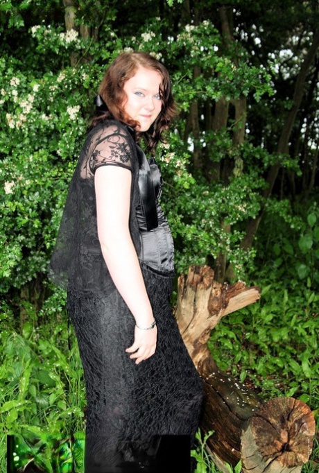 In nature wearing an attractive satin and lace ensemble, the plucky brunette MILF is captured.