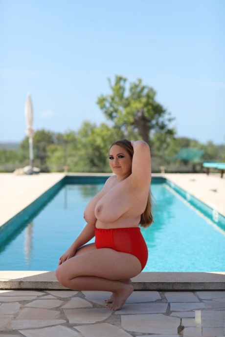 Sara Willis, the feisty model known for her size 8, exposes her large tits and squeezes them in front of the pool.