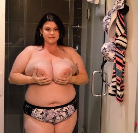 BBW Kimmie, the brunette, enjoys her shower with milk and milk on her big breasts.