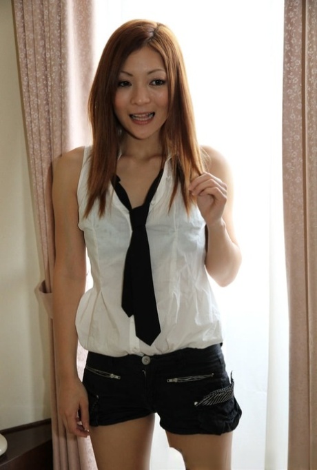 When she returns from school, Asian beauty exposes herself to her own pussy for a quick moment.