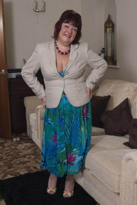 A mature housewife named Helen is teasing her lingerie and dildos.